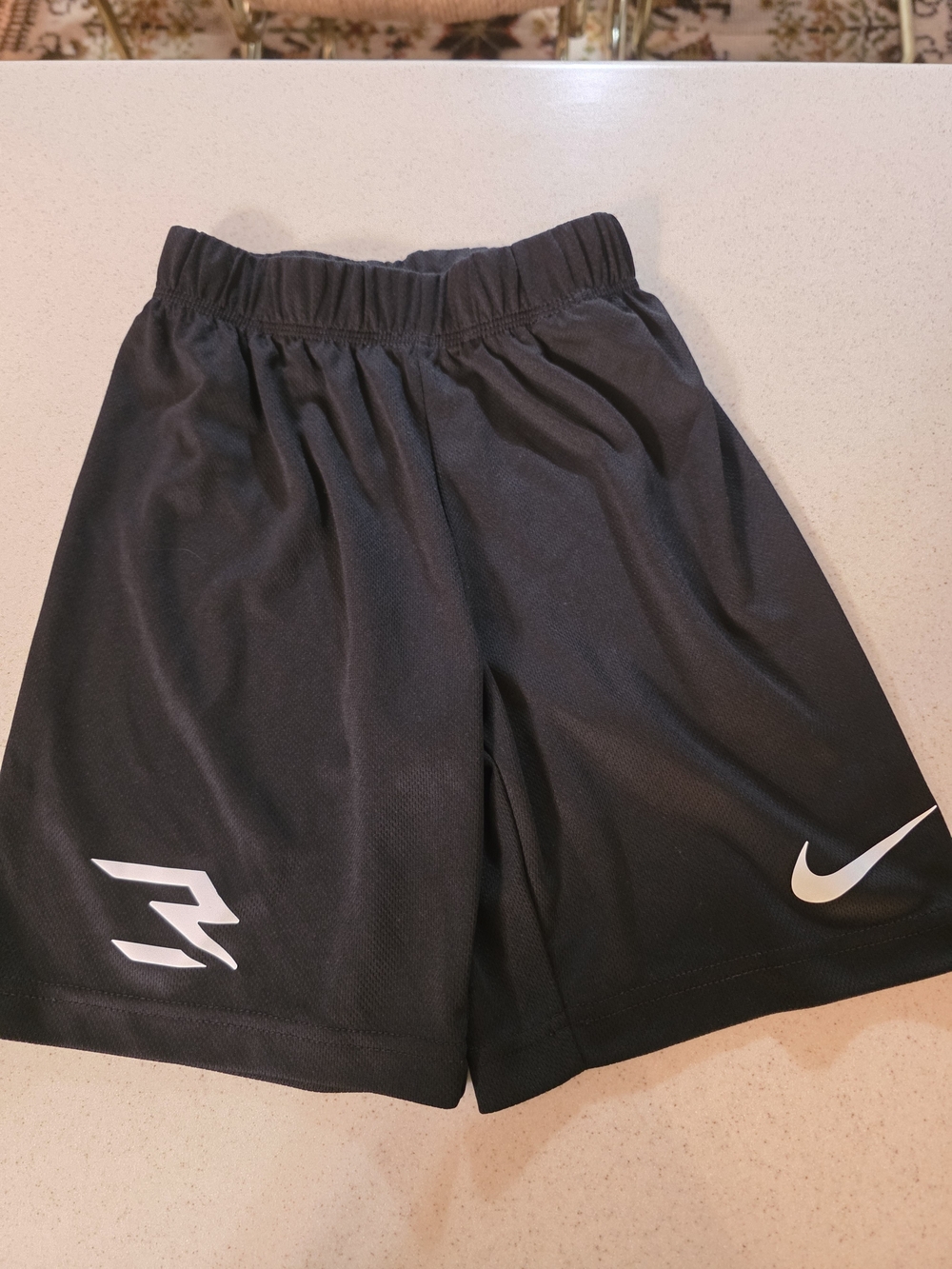 Nike Kids Black Athletic Shorts with White Swoosh and Side Graphic
